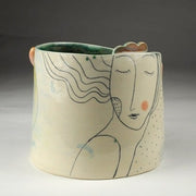 Ceramic vase sculpture with a woman design