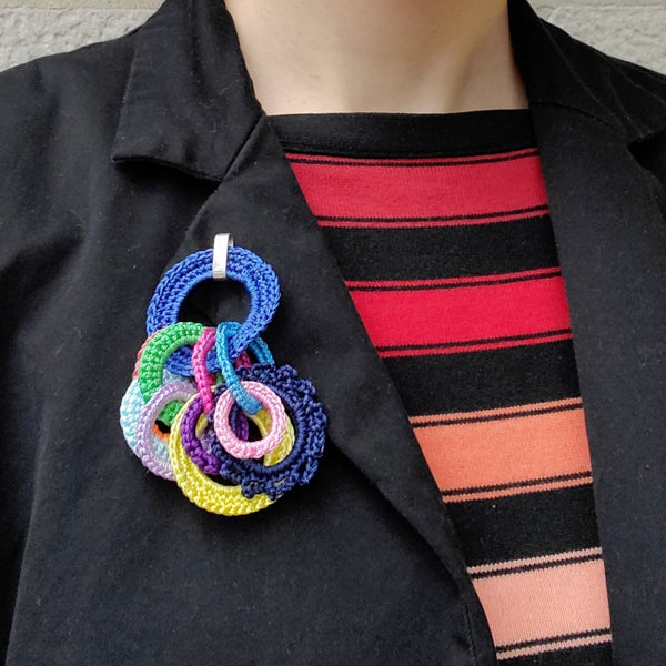 Zenith brooch in blue and multicolour - made from crocheted polyester threads and sterling silver hooks.