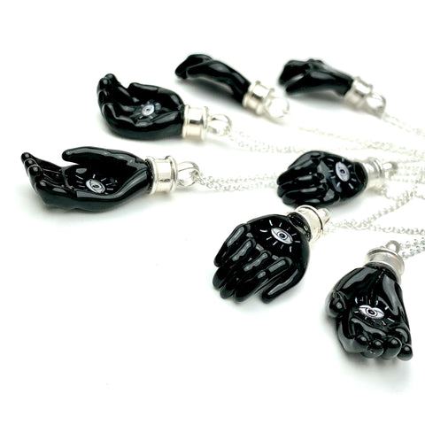 Helping hand: small murrine glass and hot-worked glass pendant on a 20" sterling silver chain.