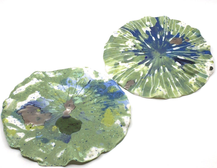 Large lily pads made from multi-fired porcelain that can be hung or laid flat. These are stunning when shown together or paired with Lisa's lily flowers.
