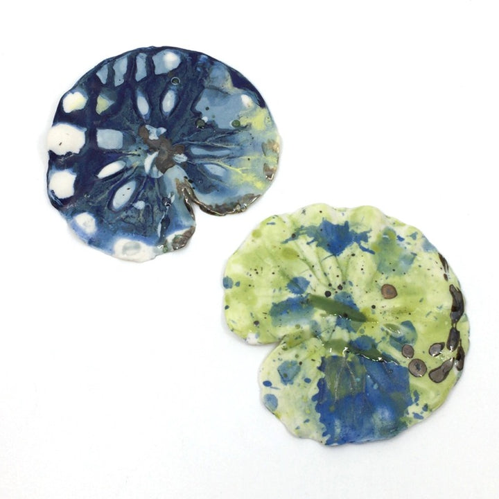 Medium lily pads made from multi-fired porcelain that can be hung or laid flat. These are stunning when shown together or paired with Lisa's lily flowers.