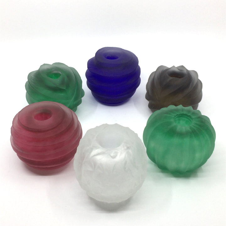 Small round glass candle holders in an assortment of vibrant and refreshing colours.   Turn them over...and use them as a small vase or pencil holder! Each sold separately.