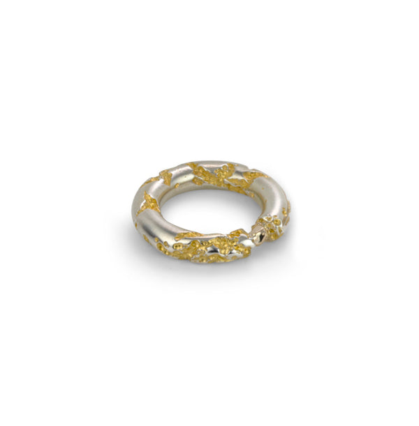Core Sample Torus Ring in sterling silver and 24k yellow gold plating in the crevasses has a solid 14K yellow gold nugget. This ‘rock’ is placed into the cut-away portion to mimic a tension-set stone.
