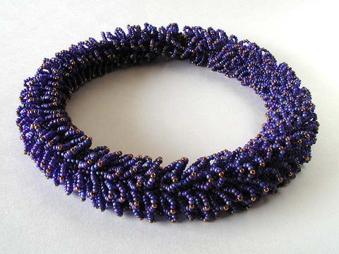 Blue and bronze Caterpillar Necklace with glass beads, and thread.
