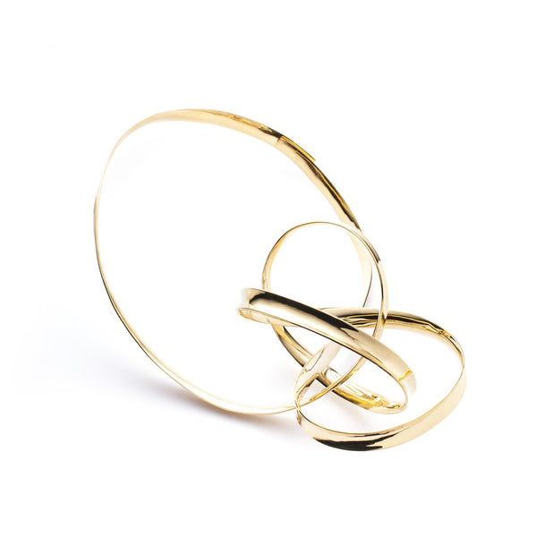 Anticlastic formed and forged necklace of gold plated brass. The centerpiece is a bold, knot-shaped form.