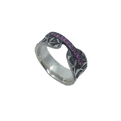 Hand stamped sterling silver ring with a line of pink sapphires.   Size 6.5