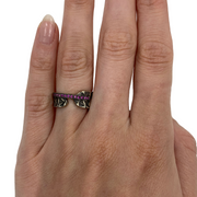 Hand stamped sterling silver ring with a line of pink sapphires.   Size 6.5