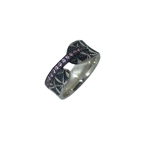 Hand stamped sterling silver ring with a line of light pink sapphires.   Size 6