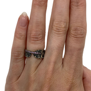 Hand stamped sterling silver ring with a line of light pink sapphires.   Size 6