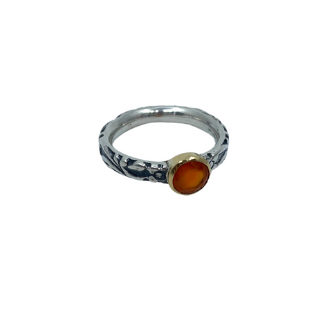 Hand stamped sterling silver ring featuring a carnelian set in a 18k gold bezel.   Size 7