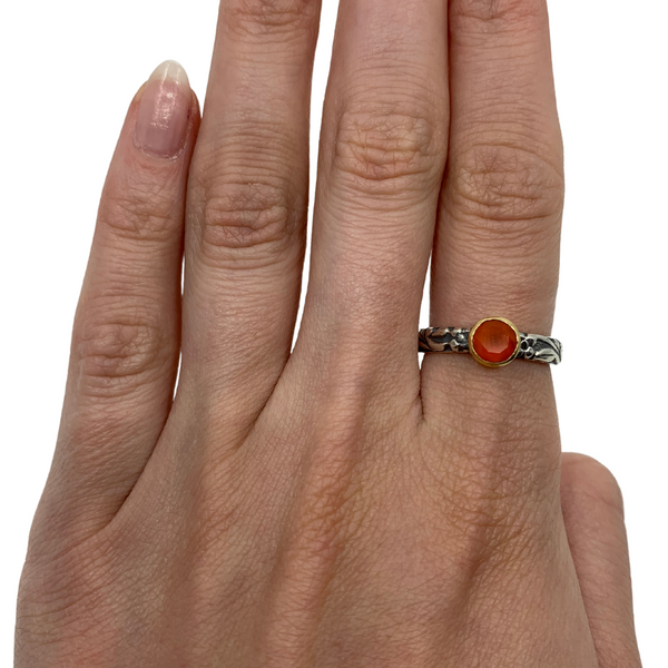 Hand stamped sterling silver ring featuring a carnelian set in a 18k gold bezel.   Size 7