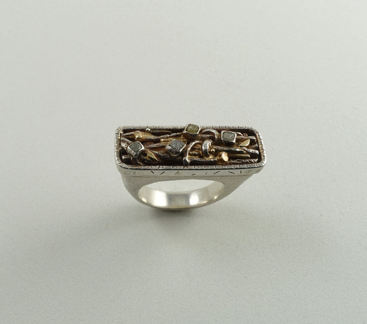 One-of-a-kind ring with four rough diamonds and 18k gold detailing. The design, featuring forms of leaves and branches within a rounded rectangle, was inspired by a forest floor.