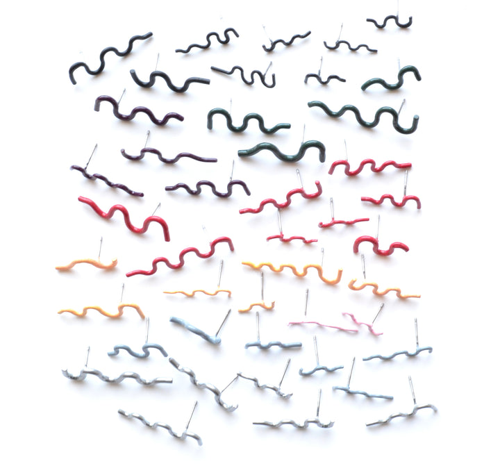 Squiggle stud earrings are colourfully powder coated copper on surgical stainless steel posts. Each is sold as a  single earring so different combinations are possible. We have a wide selection of colours in the gallery!
