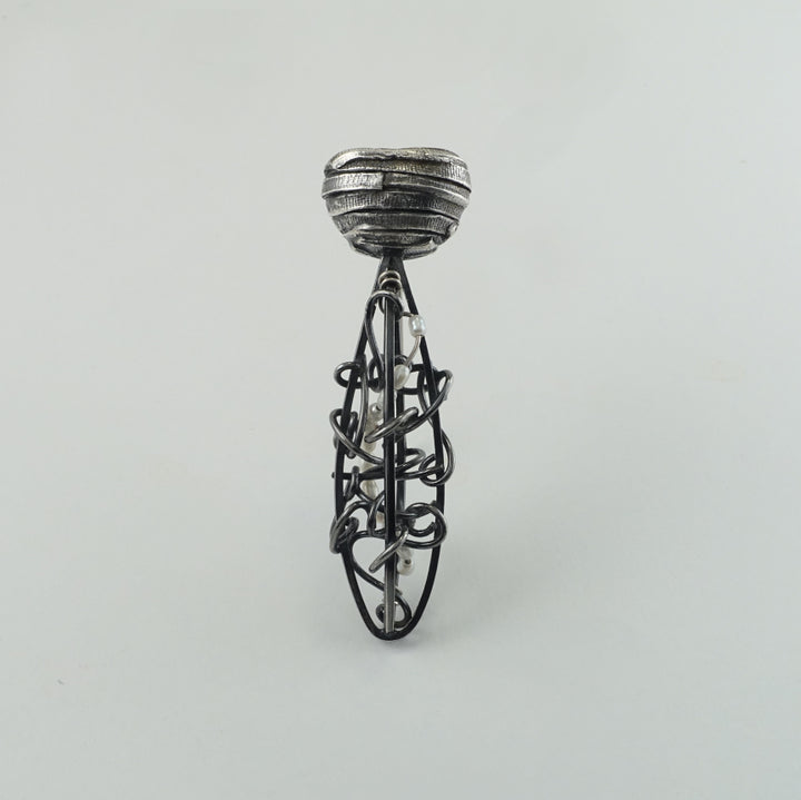 One-of-a-kind oxidized sterling silver brooch with pearls. The shapes are reminiscent of vines climbing a trellis.